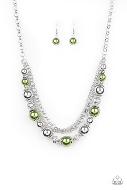 Layers of mismatched silver chains give way to a strand of ornate silver beads and oversized green pearls that cascade below the collar for a refined flair