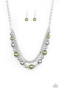 Layers of mismatched silver chains give way to a strand of ornate silver beads and oversized green pearls that cascade below the collar for a refined flair