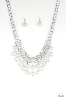 imperfect white pearls dangle from a web of interlocking silver links below the collar